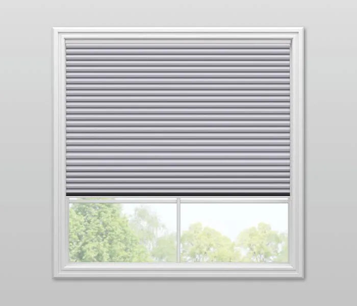Cordless top-down bottom-up cellular shade in gray installed on a window, showing upper blackout panel and lower light-filtering section for flexible privacy control in nursery or kids' room