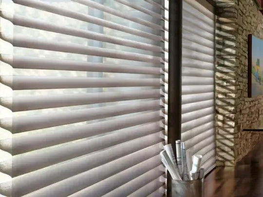 Hands pushing up the bottom rail to shorten mini blinds that are too long