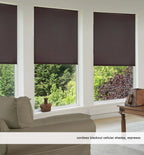 Three cordless dark blackout cellular window shades mounted on picture windows in a modern peaceful bedroom
