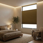 Cordless top down bottom up light filtering honeycomb shade above master bed with warm morning sunlight
