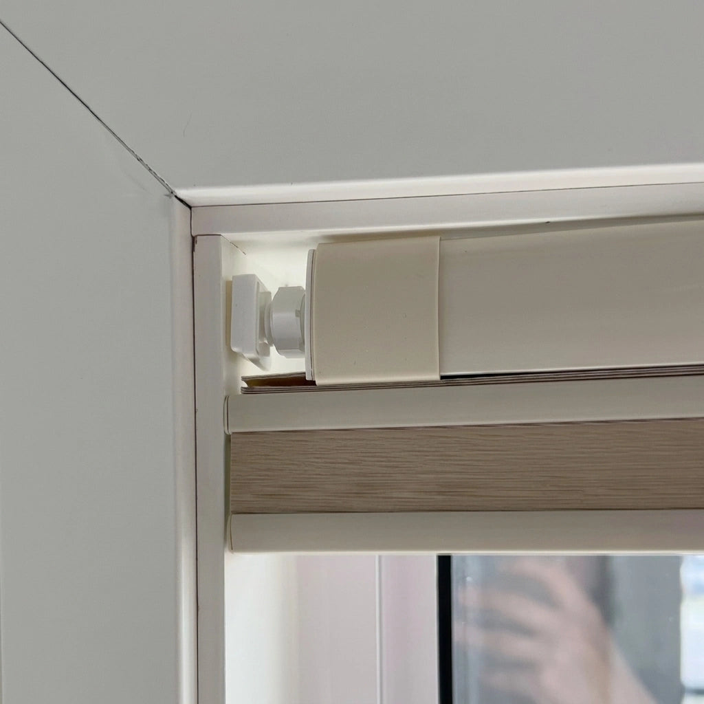Close up of no drill honeycomb shade tension headrail corner with soft silicone foot pad and hex lock nut

