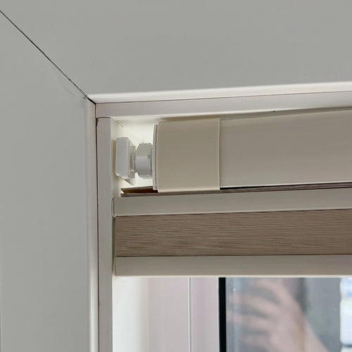 Close up of no drill honeycomb shade tension headrail corner with soft silicone foot pad and hex lock nut

