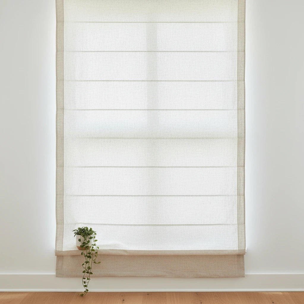 Light filtering Roman shades in bedroom with warm ambient light — custom made-to-measure cordless window blinds for US, Canada and Australia
